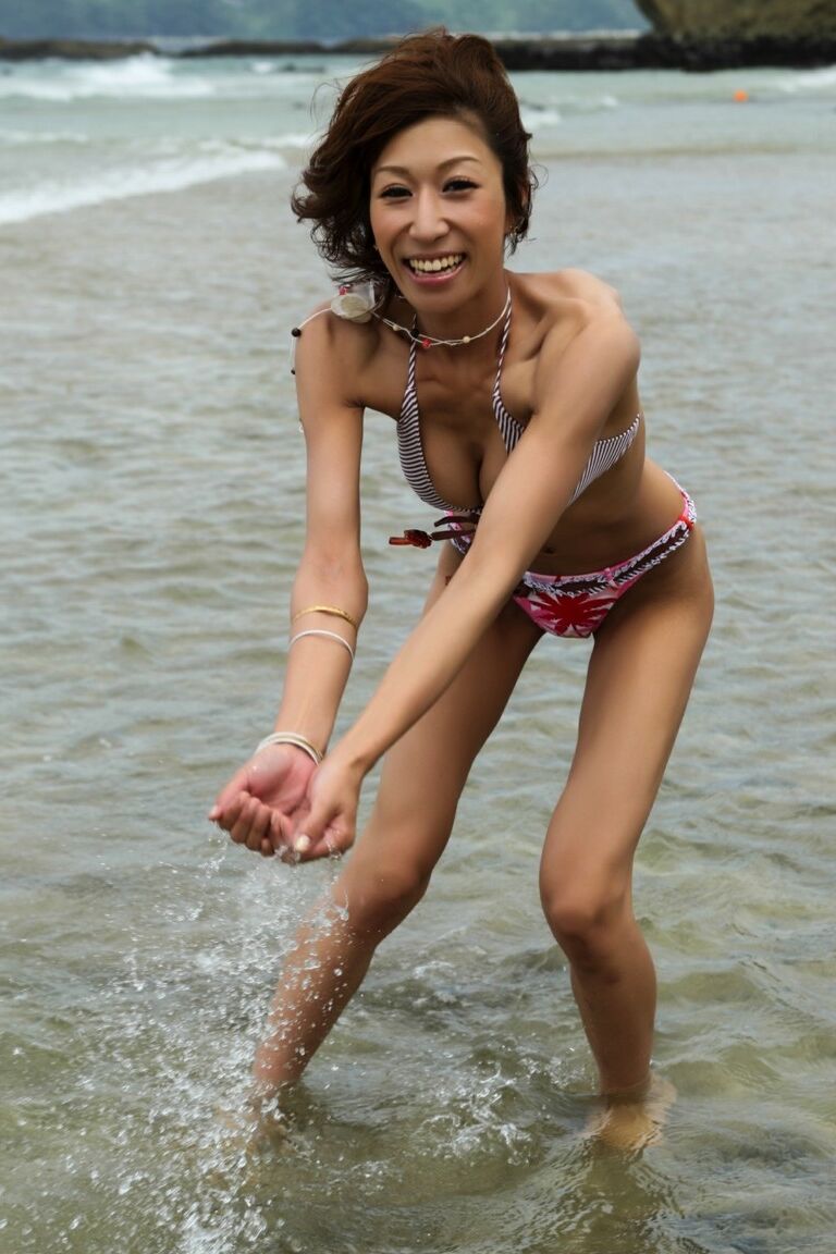 12P Japanese girl wears a bikini while playing in the ocean during a beach holiday