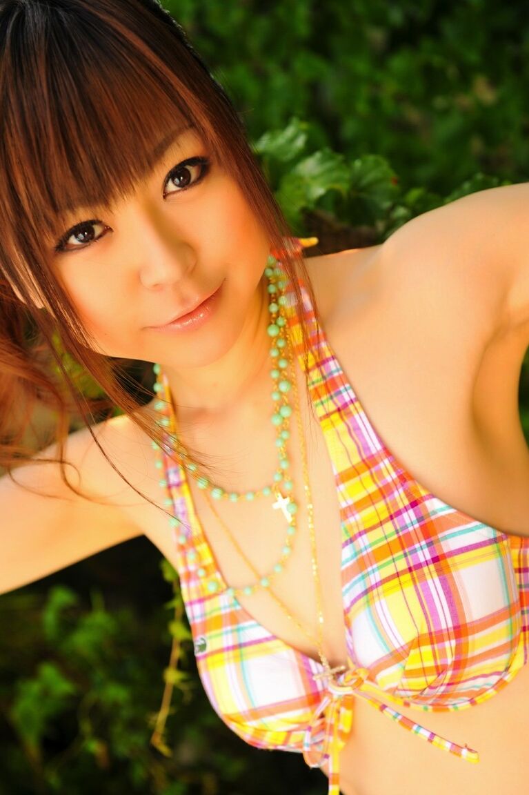 12P Tiny Asian girl wears her hair in a ponytail while modeling a bikini by a pool