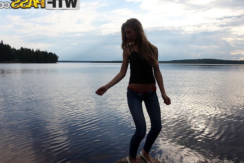 16P Girl next door Megan pulls out her tits while sitting on a rock in the lake