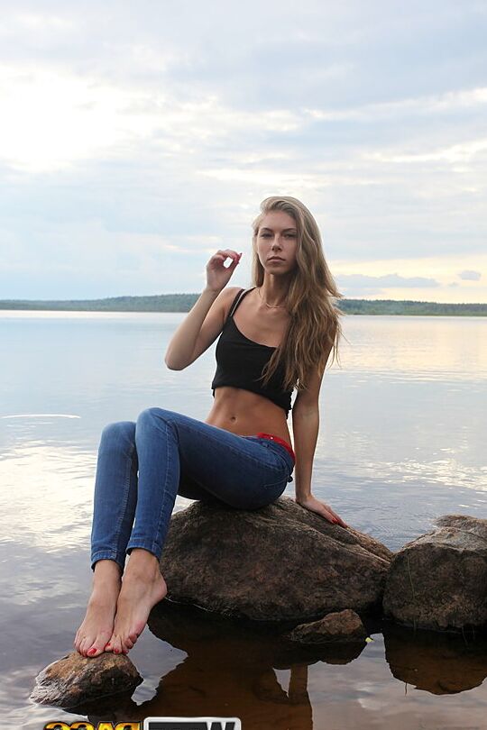 16P Girl next door Megan pulls out her tits while sitting on a rock in the lake