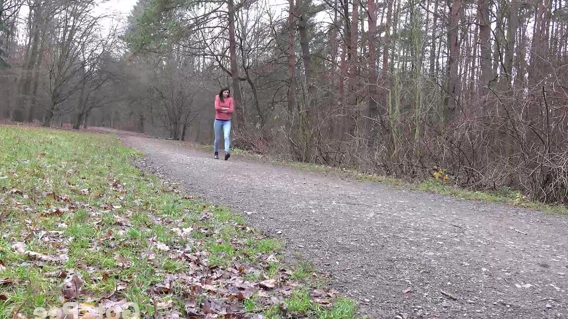15P Tiny Tina squats on a wooden bench alongside a path for an urgent piss