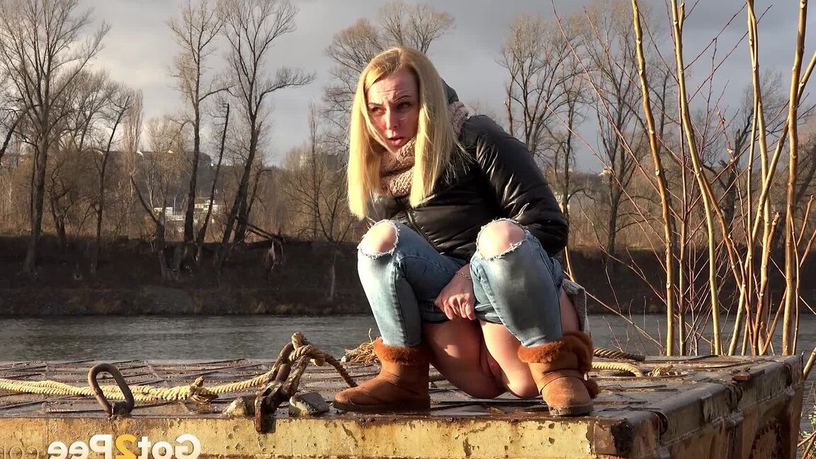15P Pretty blonde squatting to pee by the river
