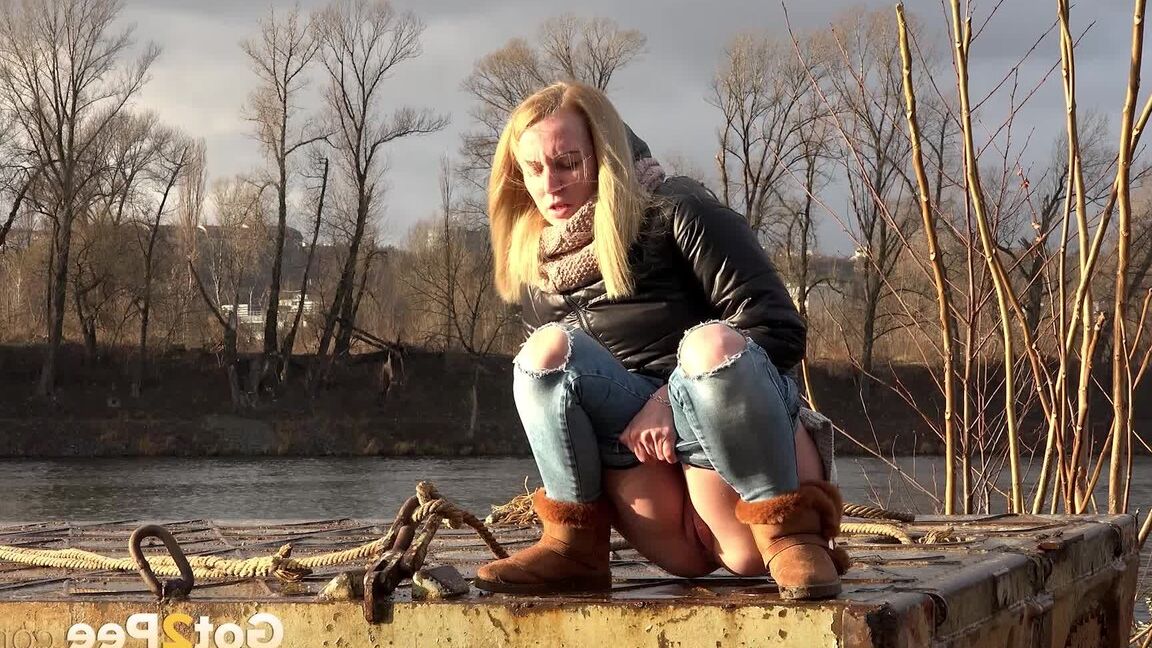 15P Pretty blonde squatting to pee by the river