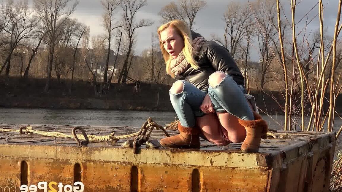 15P Pretty blonde squatting to pee by the river