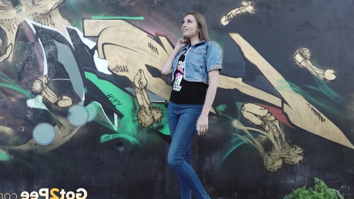 15P White girl Viktoria pulls down her jeans to take a pee near a wall of graffiti