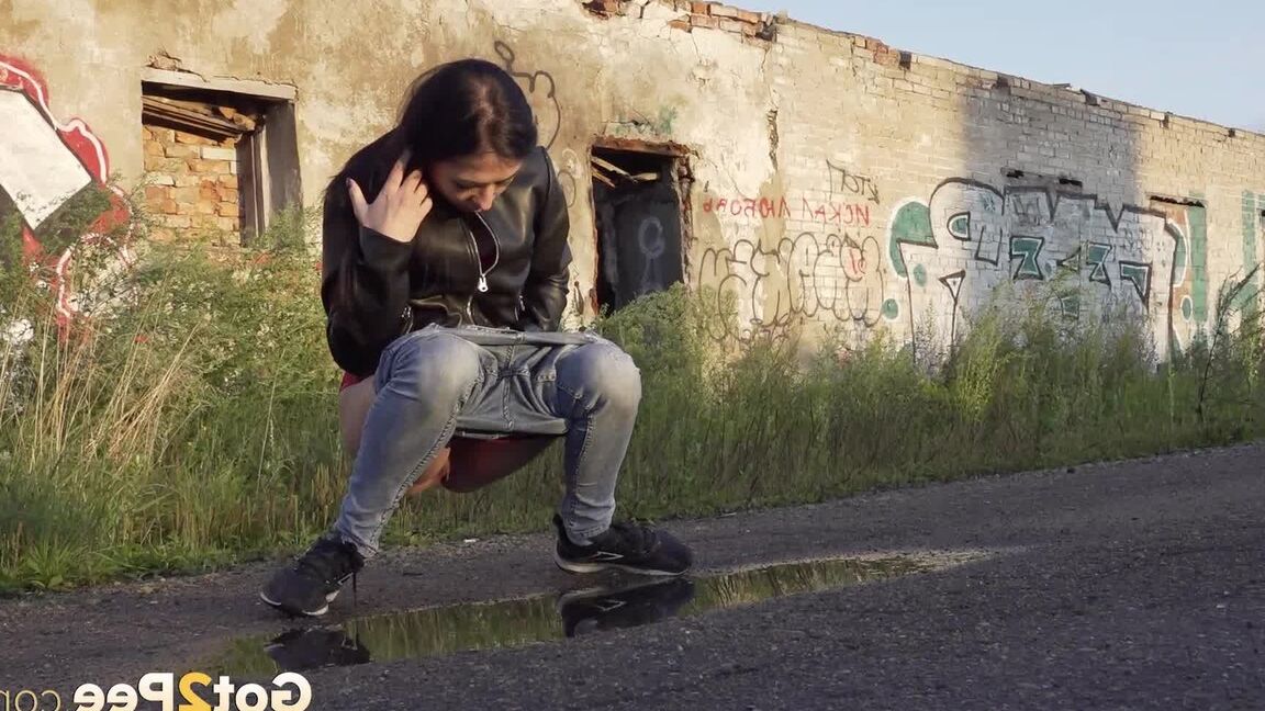 15P Petite brunette Natasha squats for a piss in a puddle on a gravel road