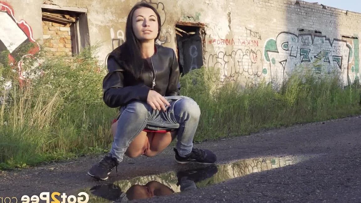 15P Petite brunette Natasha squats for a piss in a puddle on a gravel road
