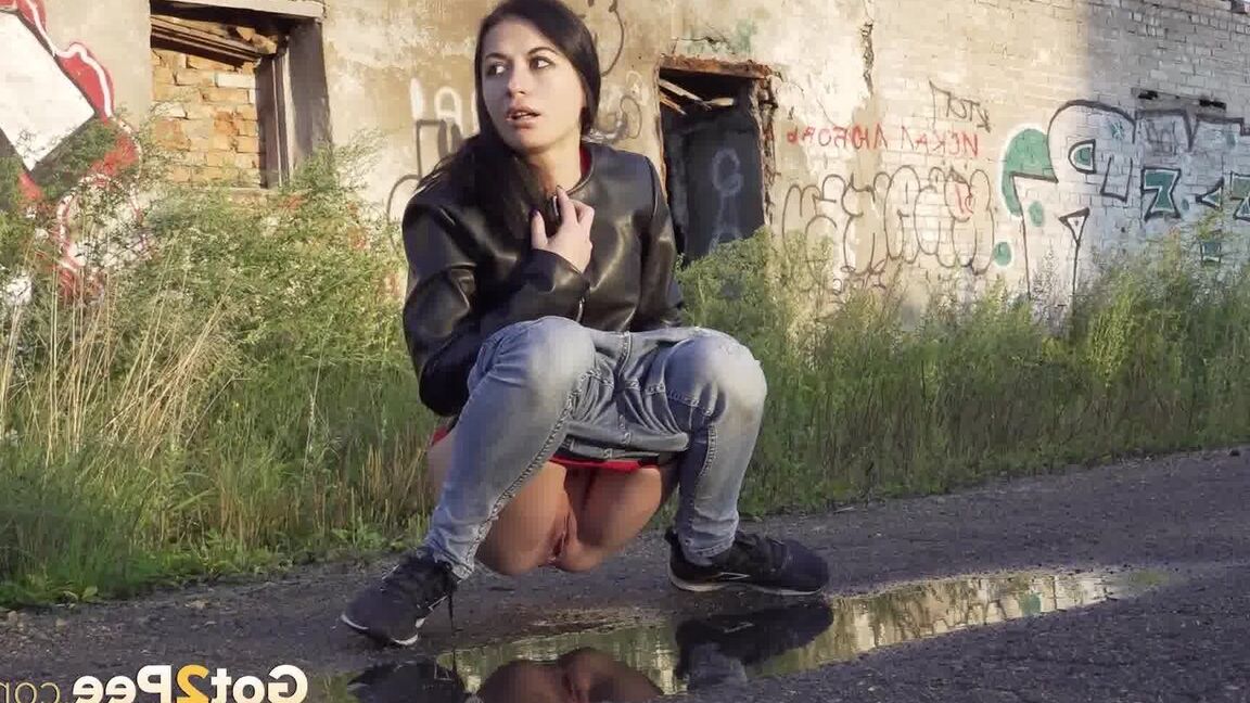 15P Petite brunette Natasha squats for a piss in a puddle on a gravel road