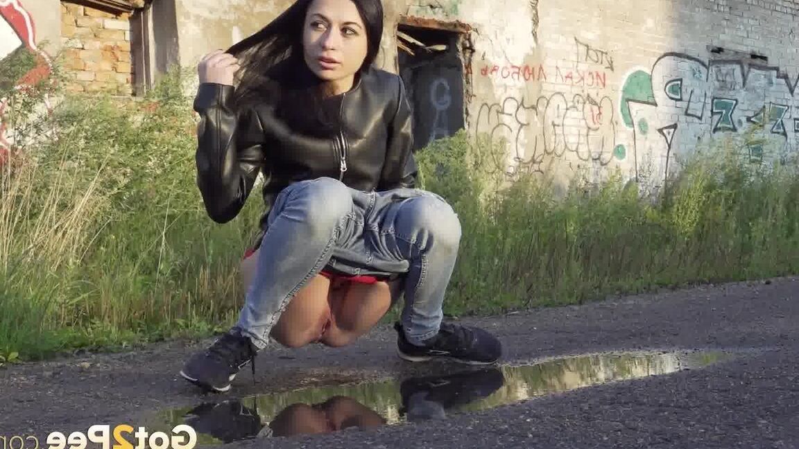 15P Petite brunette Natasha squats for a piss in a puddle on a gravel road