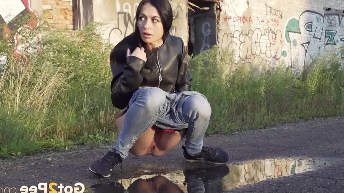 15P Petite brunette Natasha squats for a piss in a puddle on a gravel road