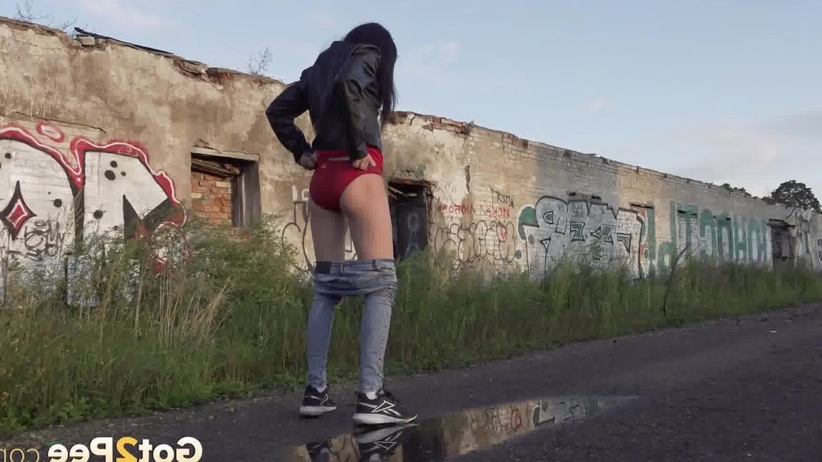 15P Petite brunette Natasha squats for a piss in a puddle on a gravel road