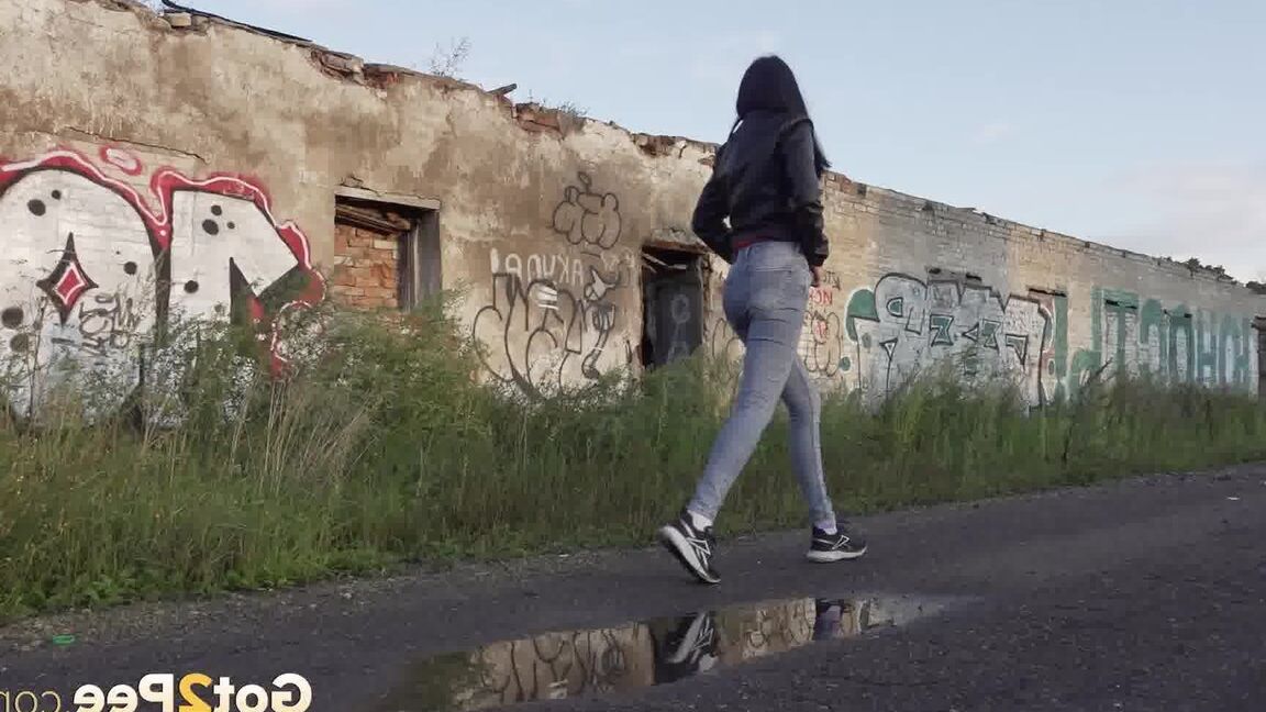 15P Petite brunette Natasha squats for a piss in a puddle on a gravel road