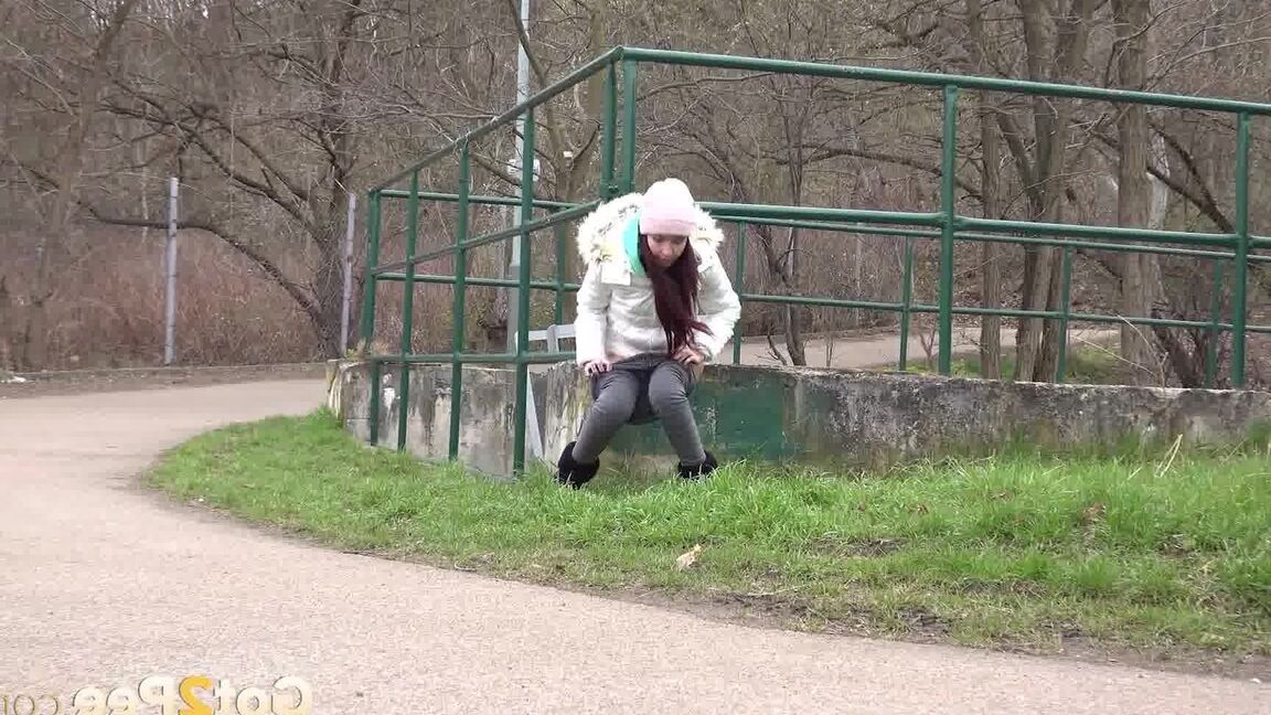 15P Clothed girl Mistica squats for a pee beside the road in winter clothing