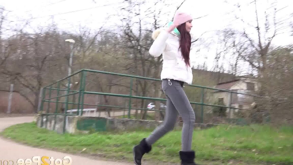 15P Clothed girl Mistica squats for a pee beside the road in winter clothing