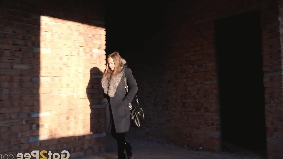 15P Distressed girl squats for an outdoor piss while wearing a heavy winter coat
