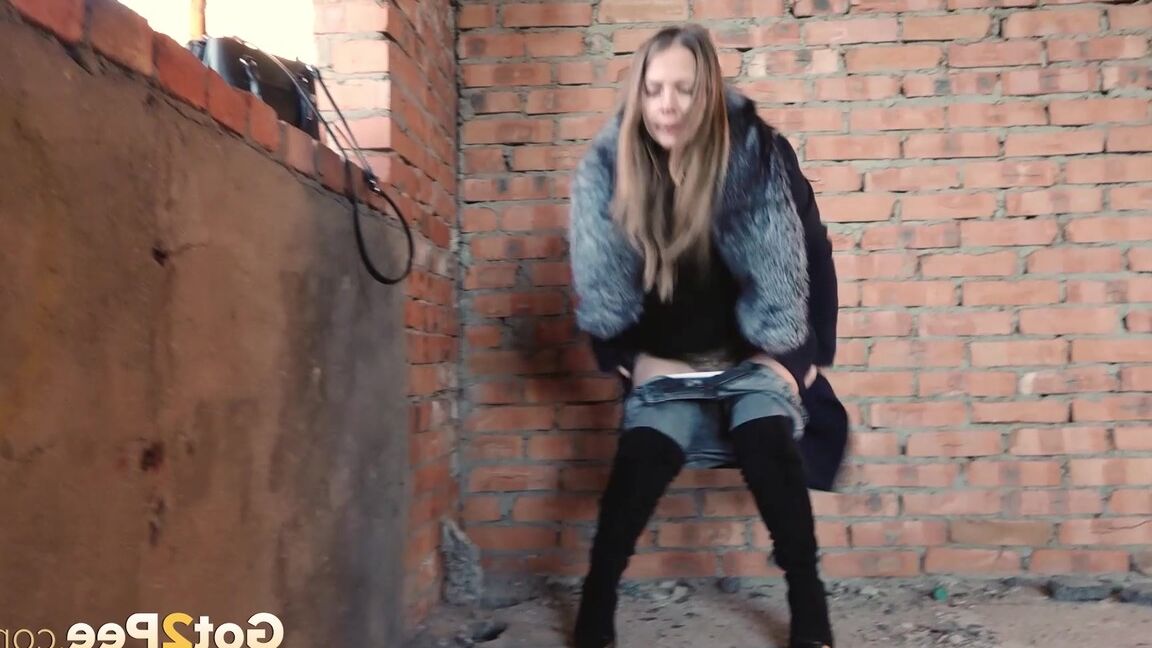 15P Distressed girl squats for an outdoor piss while wearing a heavy winter coat