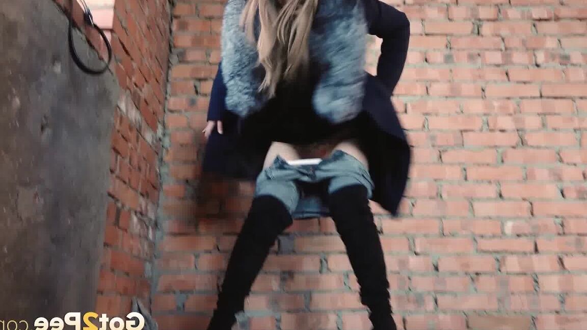 15P Distressed girl squats for an outdoor piss while wearing a heavy winter coat