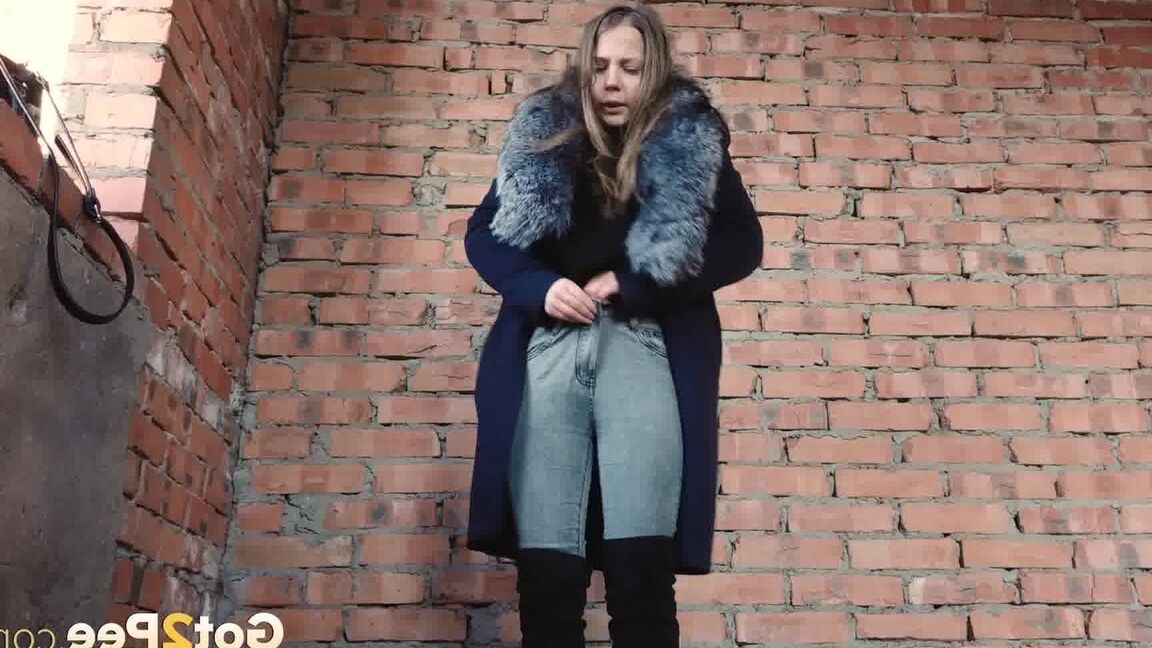 15P Distressed girl squats for an outdoor piss while wearing a heavy winter coat
