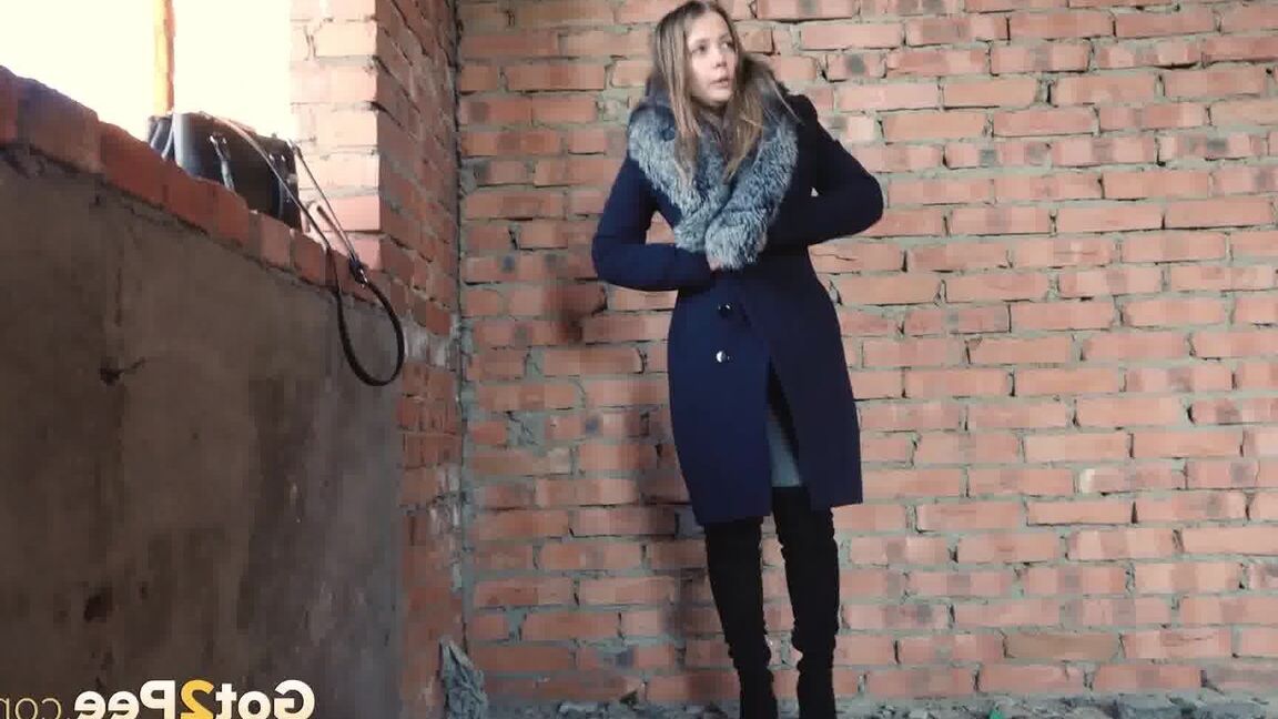 15P Distressed girl squats for an outdoor piss while wearing a heavy winter coat