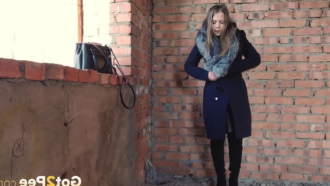 15P Distressed girl squats for an outdoor piss while wearing a heavy winter coat