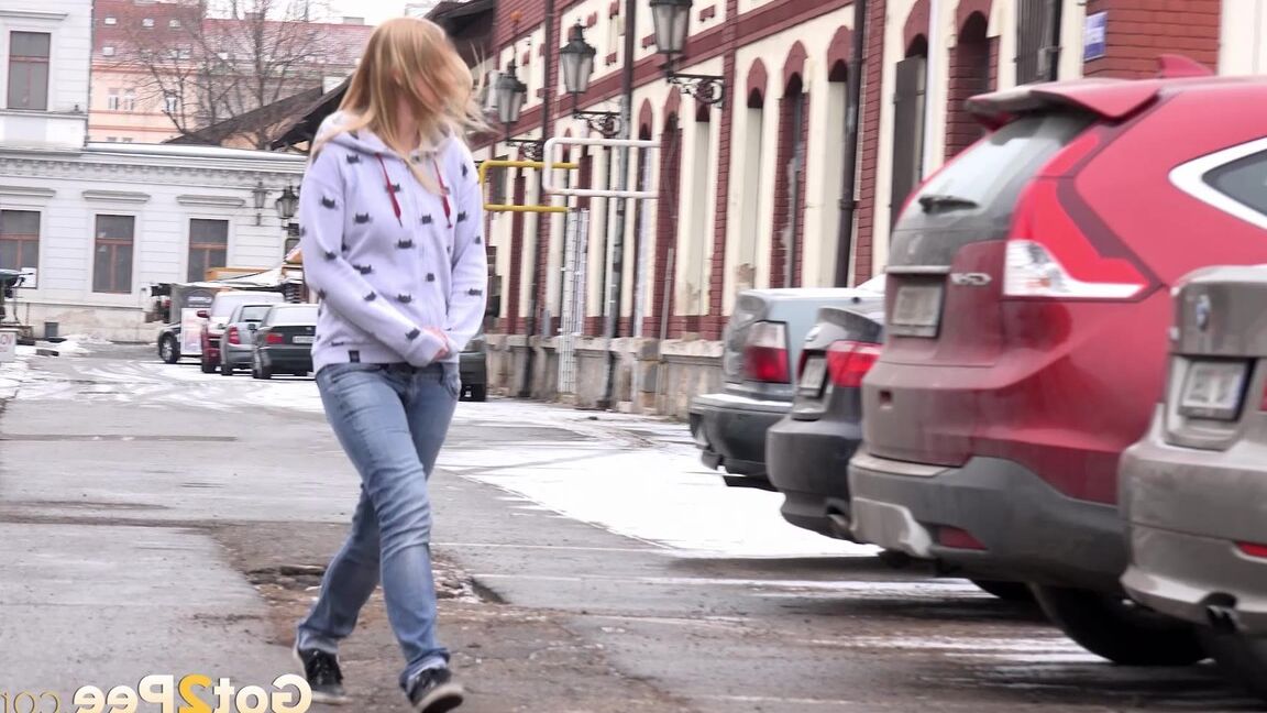 15P Blonde girl Violette squats for a pee between parked cars in the winter