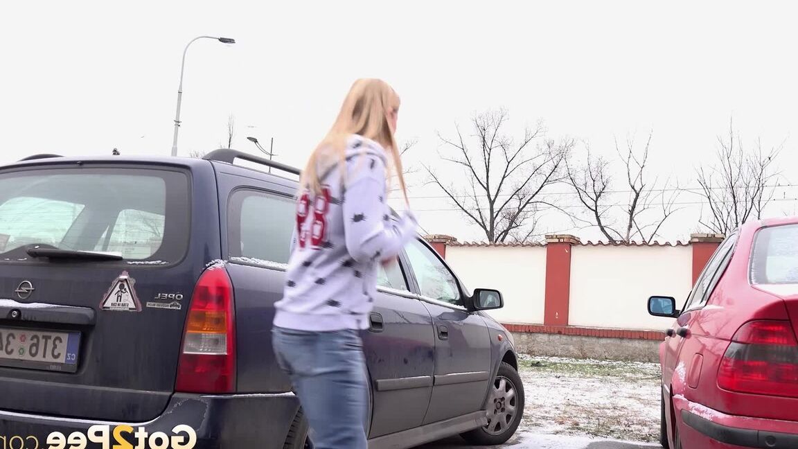 15P Blonde girl Violette squats for a pee between parked cars in the winter
