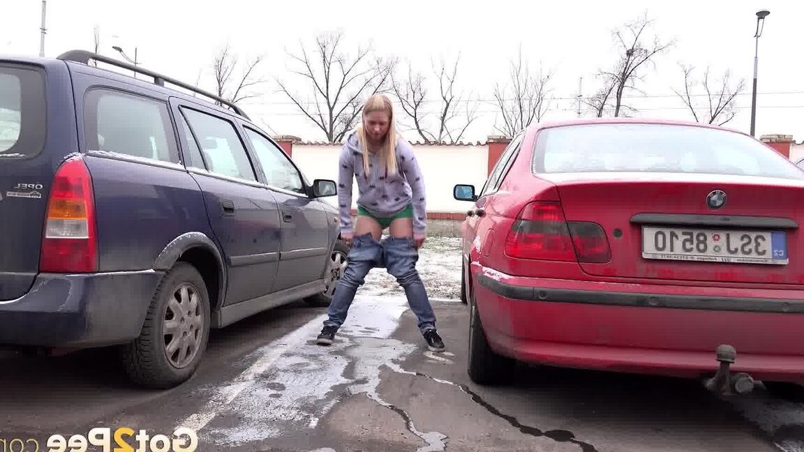 15P Blonde girl Violette squats for a pee between parked cars in the winter