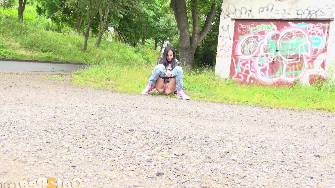 15P Solo girl with black hair squats for a piss on the side of a dirt road