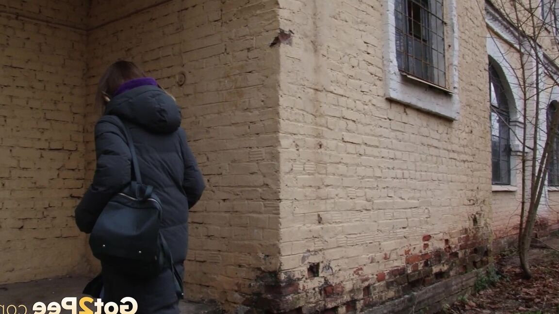 15P Pretty brunette pulls down denims to pee outside