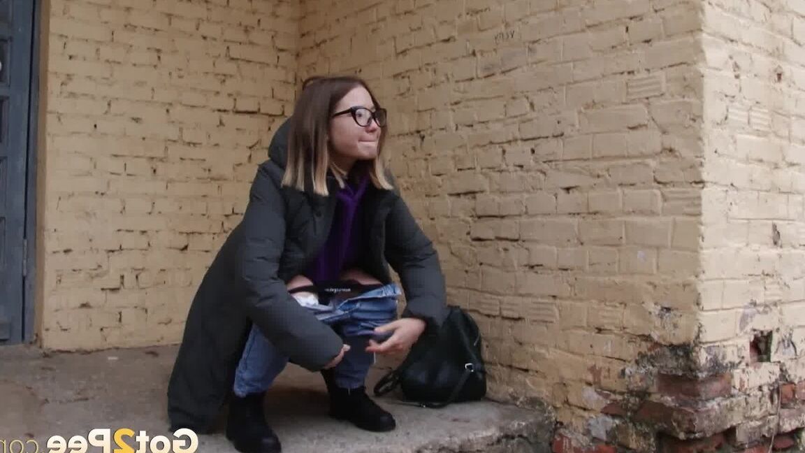 15P Pretty brunette pulls down denims to pee outside