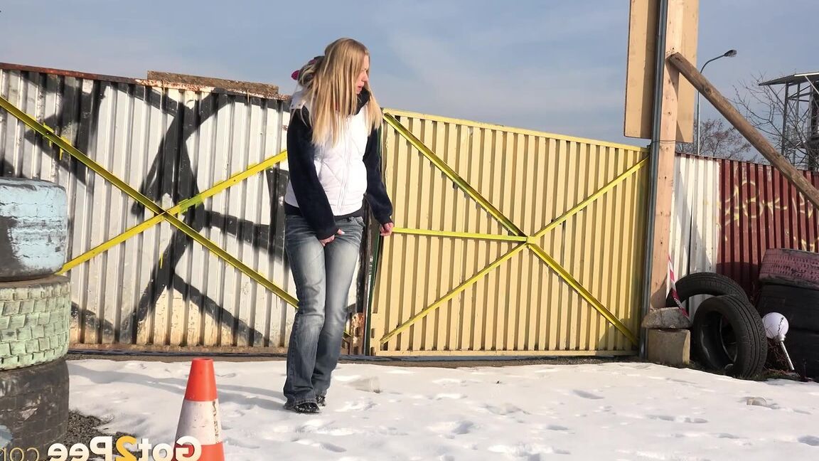 15P Blonde chick Violette pulls down her jeans to pee in the snow by a junkyard