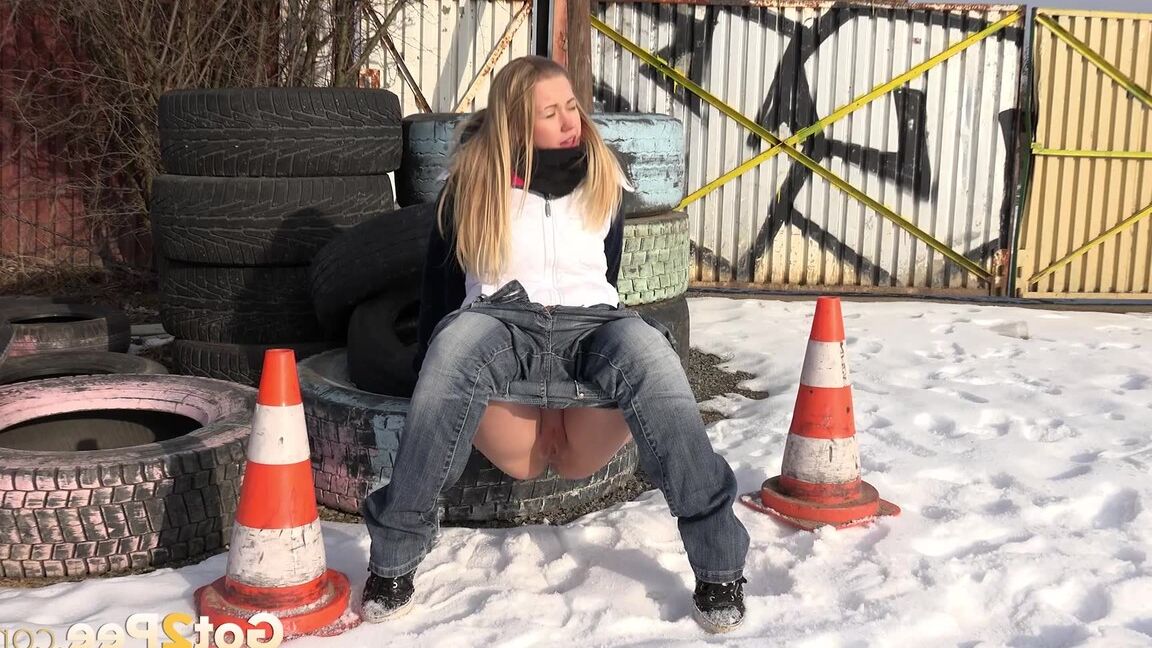 15P Blonde chick Violette pulls down her jeans to pee in the snow by a junkyard