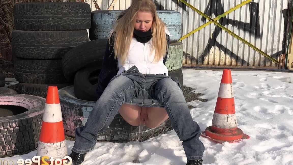 15P Blonde chick Violette pulls down her jeans to pee in the snow by a junkyard