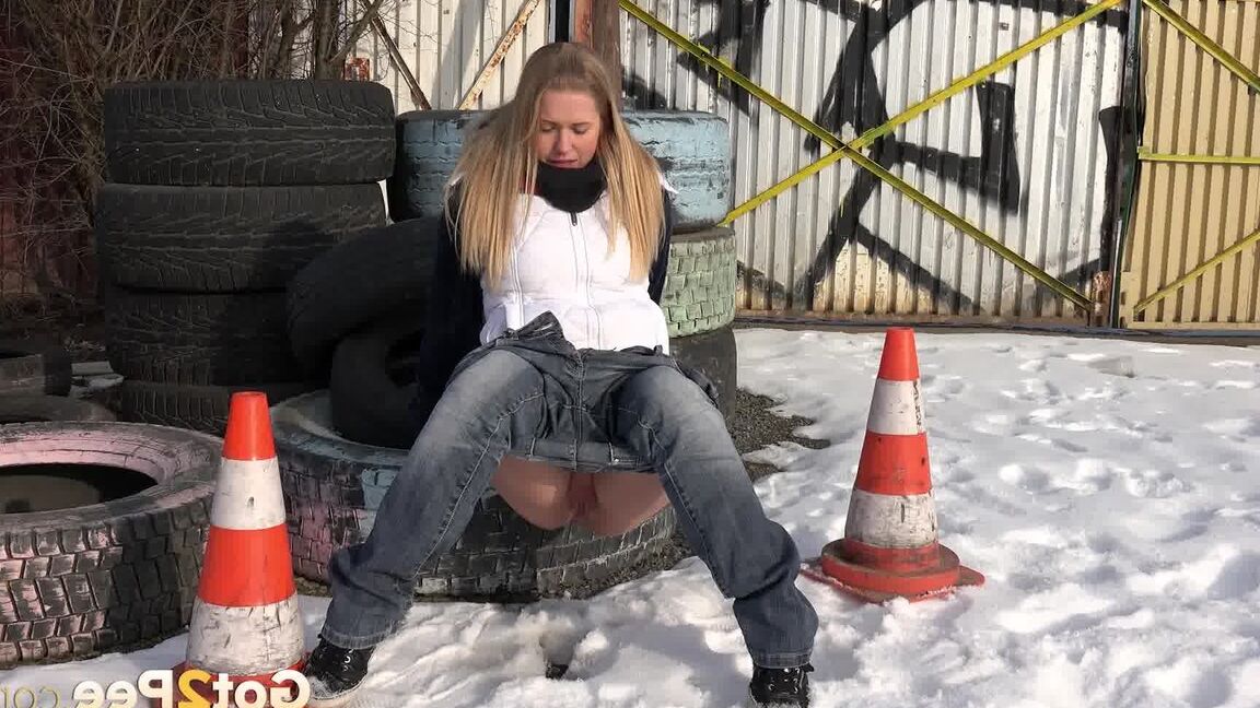 15P Blonde chick Violette pulls down her jeans to pee in the snow by a junkyard
