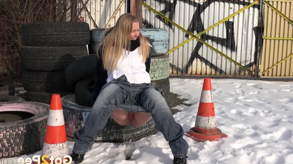 15P Blonde chick Violette pulls down her jeans to pee in the snow by a junkyard