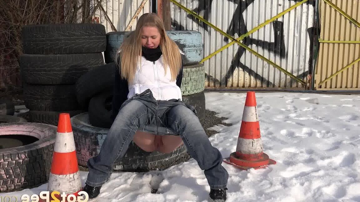 15P Blonde chick Violette pulls down her jeans to pee in the snow by a junkyard