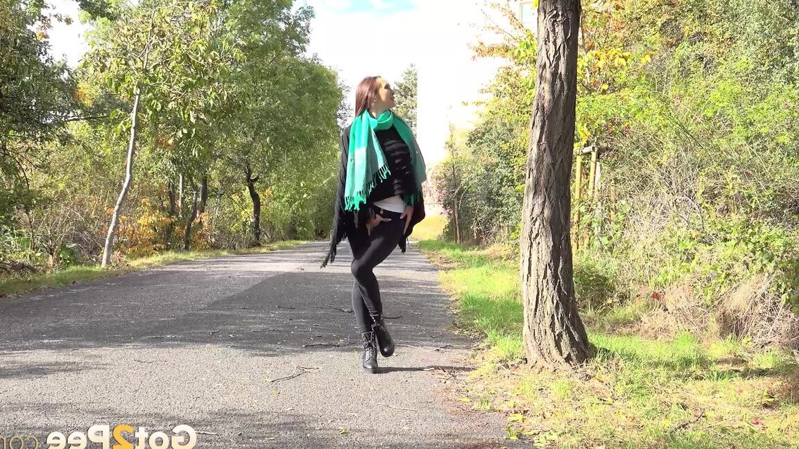 15P Caucasian girl Cynthia Vellons takes a piss while walking along a paved road