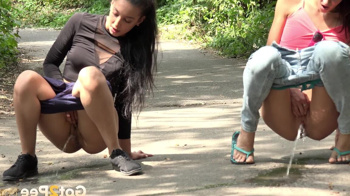 15P Gorgeous dark haired babes pee together outside