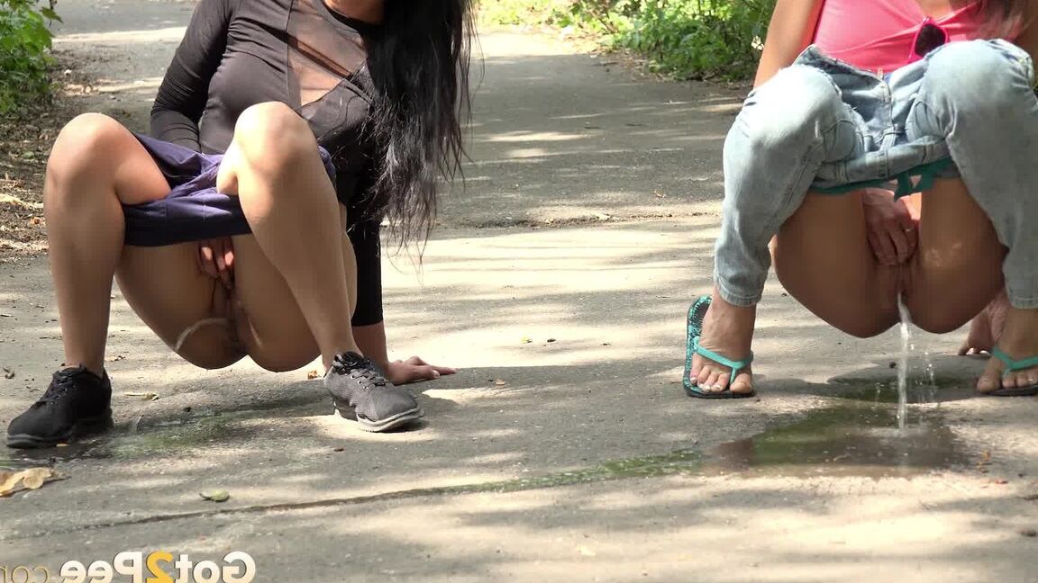 15P Gorgeous dark haired babes pee together outside