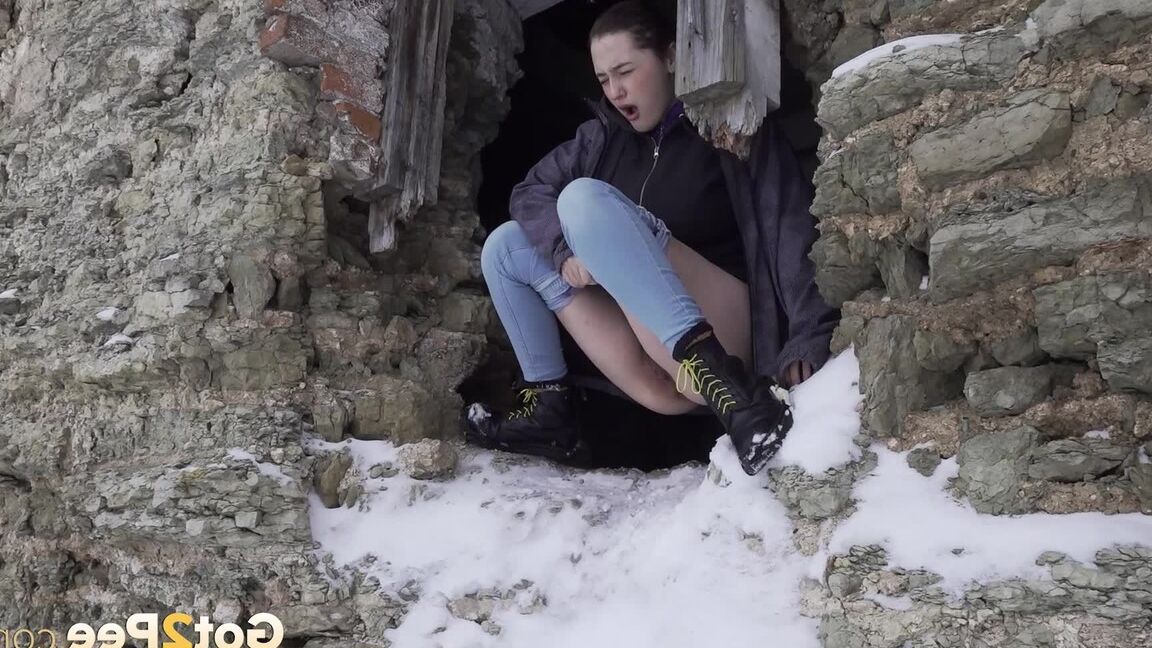 15P Hottie pees through a hole in a wall outside