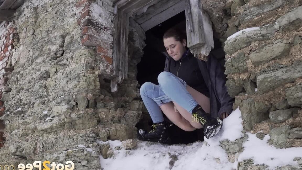 15P Hottie pees through a hole in a wall outside