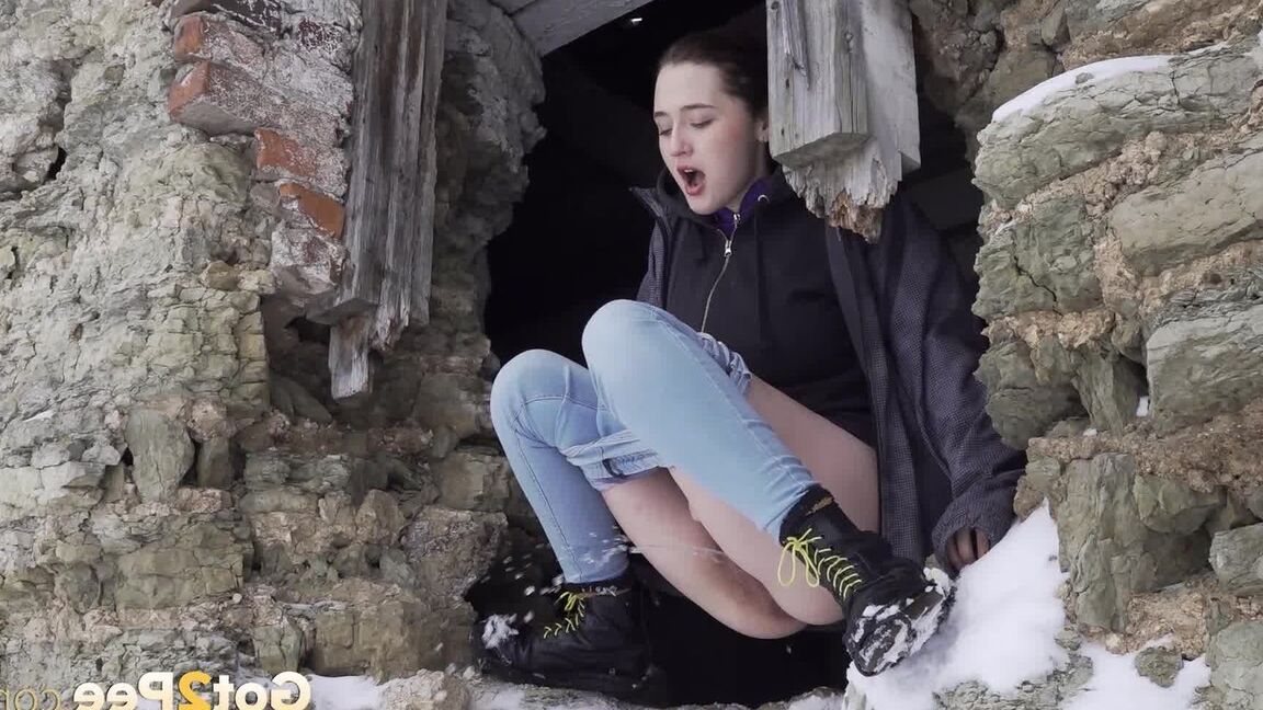 15P Hottie pees through a hole in a wall outside
