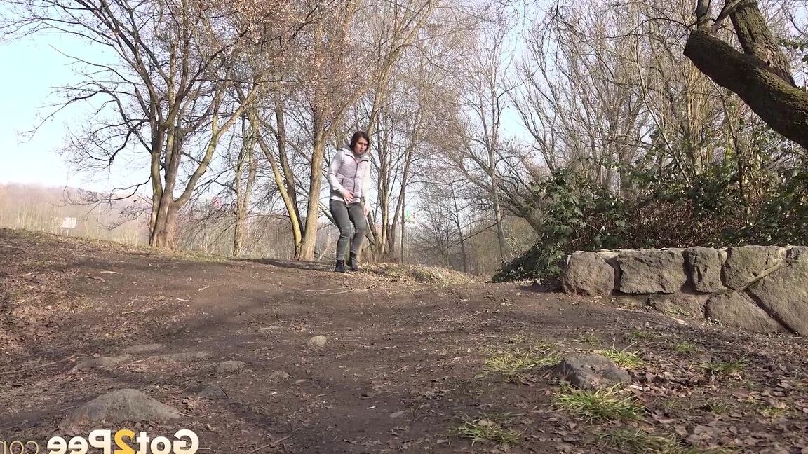 15P Lara Fox squats to pee on a stone wall