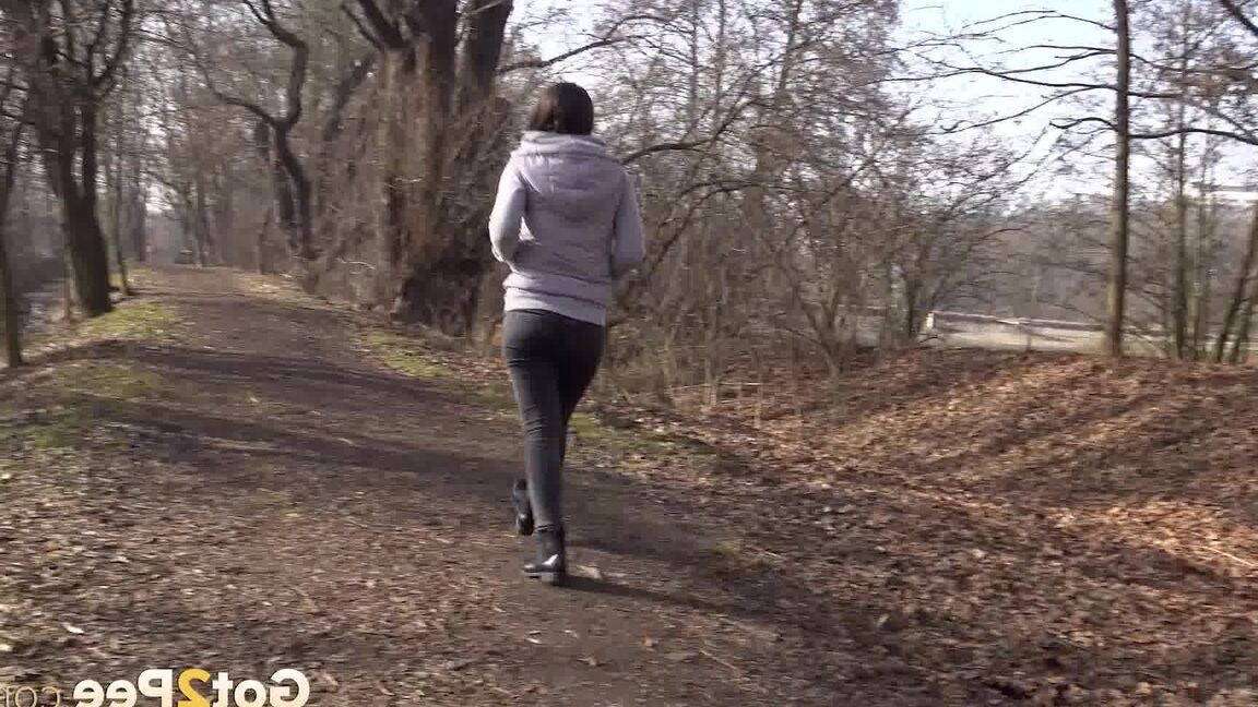 15P Lara Fox squats to pee on a stone wall