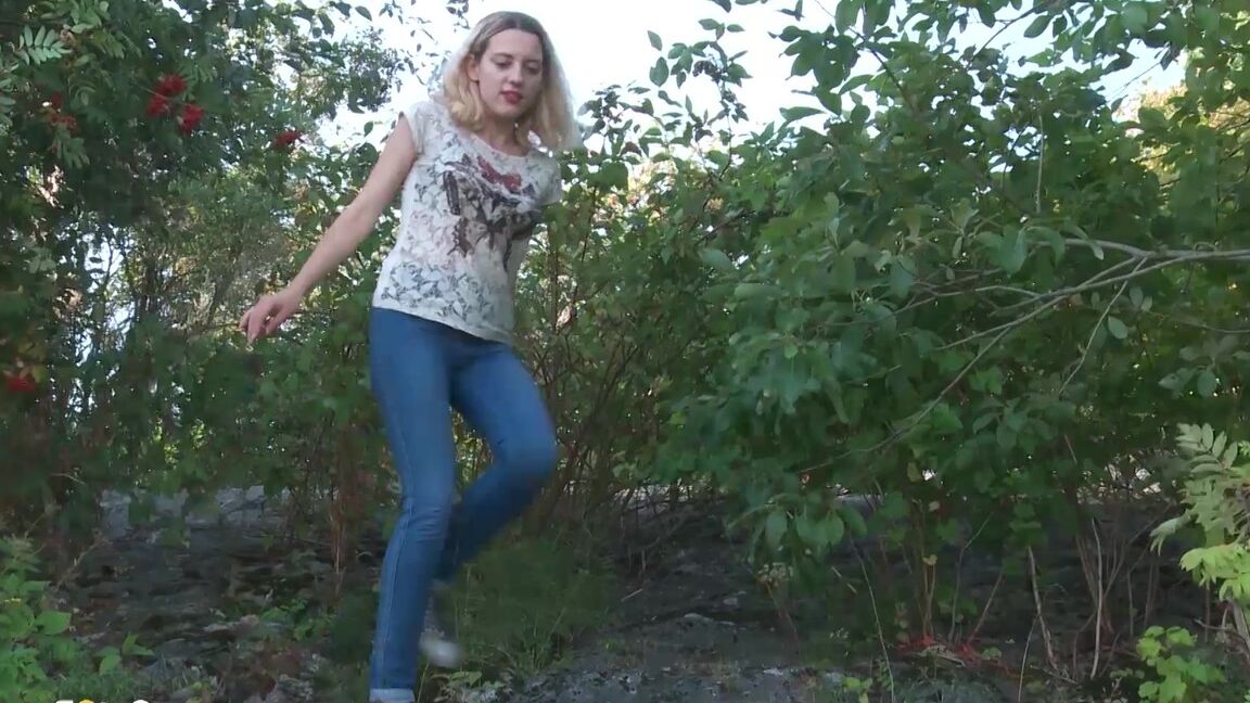 15P Blonde female Sasha is captured while taking a piss on a rocky bank