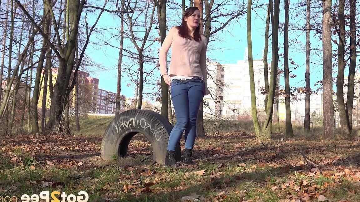 14P Natural redhead Amanda Hill takes a pee while walking through a stand of trees