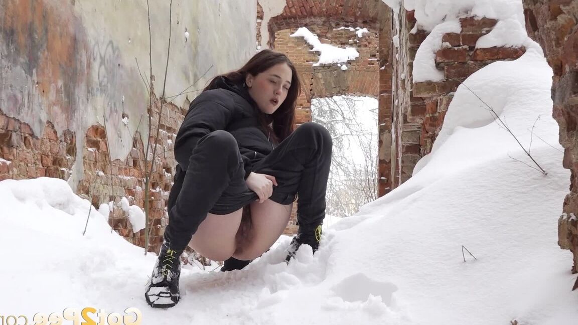15P Gorgeous babe pees on a mound of snow