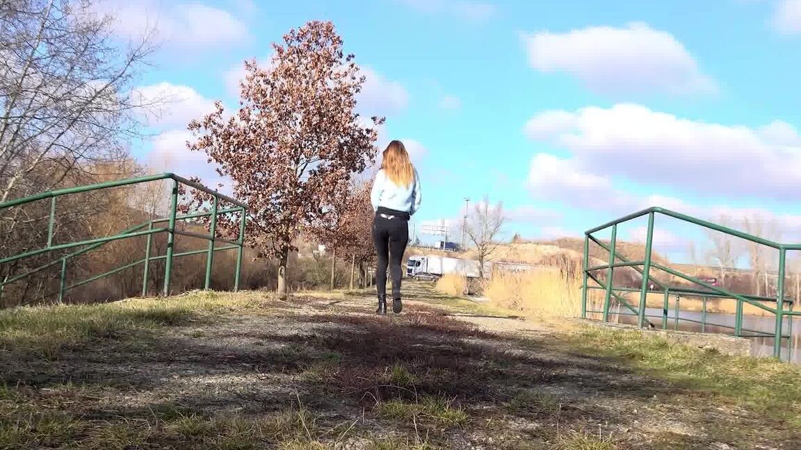 15P Cynthia Vellons squats on a tree stump to piss