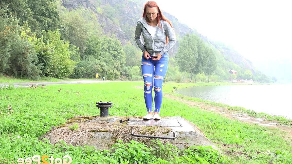 15P Redhead babe squats to pee outside by lake