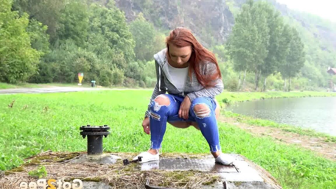15P Redhead babe squats to pee outside by lake